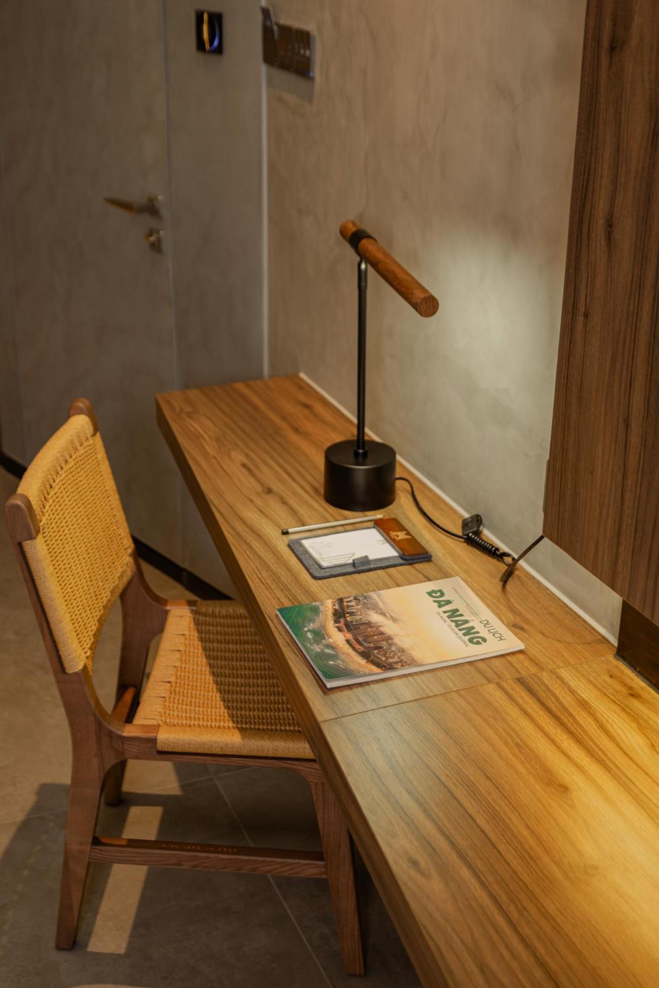 M Hotel Danang Exterior foto A desk with a magazine on it